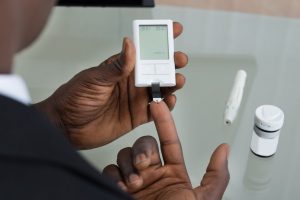 Patient Hands With Glucometer