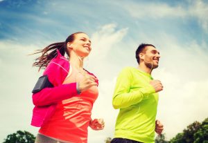 Man and woman running outside