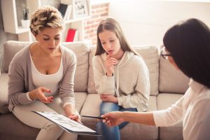 Mother and daughter talking with provider