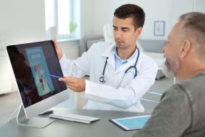 Urologist showing scans to male patient